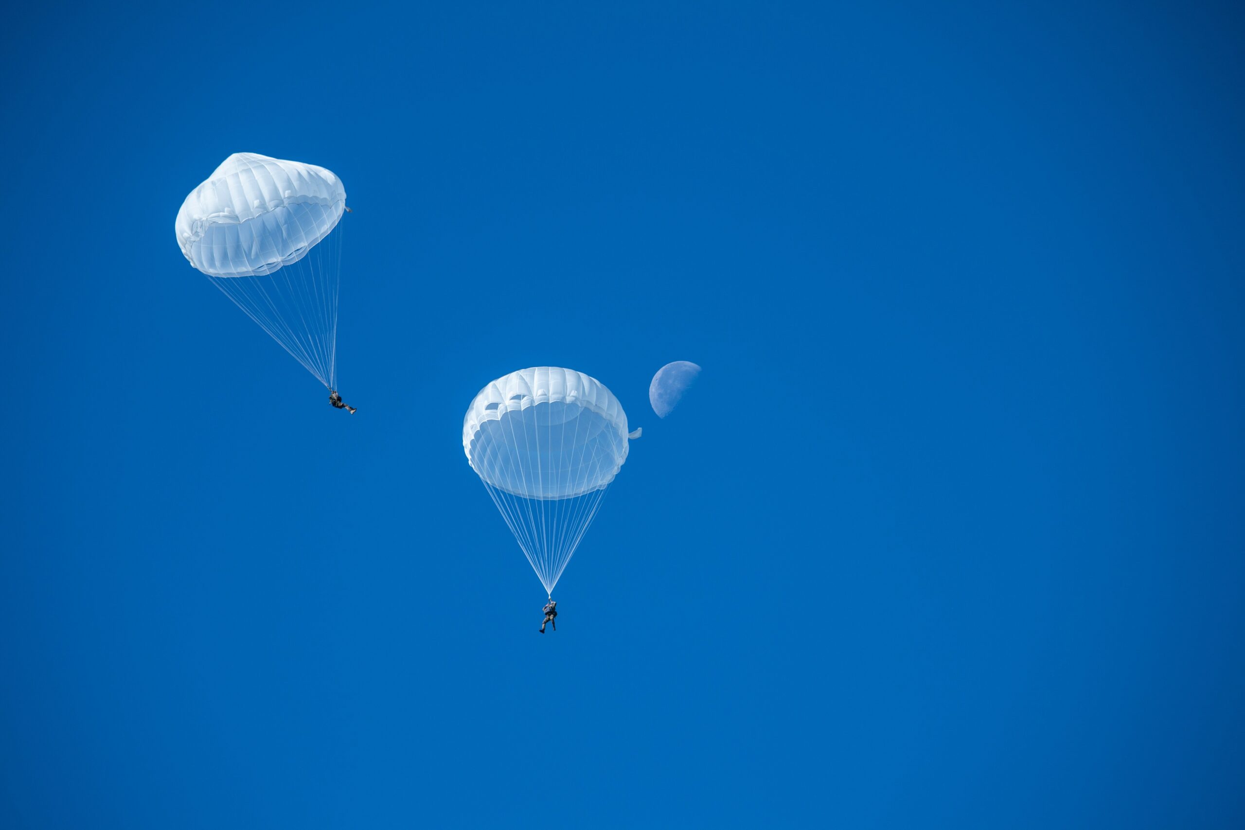 two people parachuting in the sky